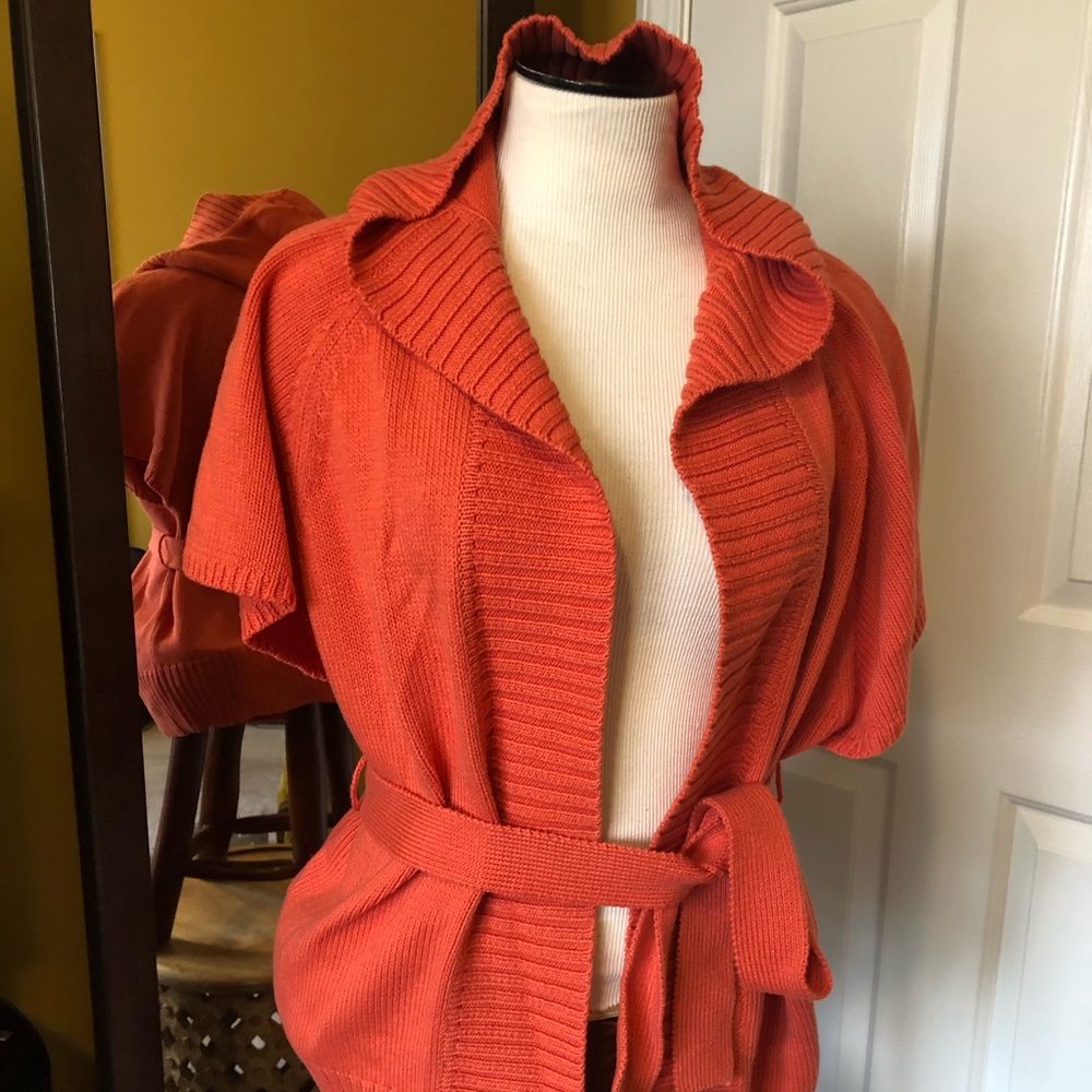 A coral colored Michael Kors cardigan
